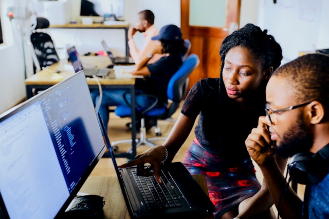 a woman training a man on computer skill