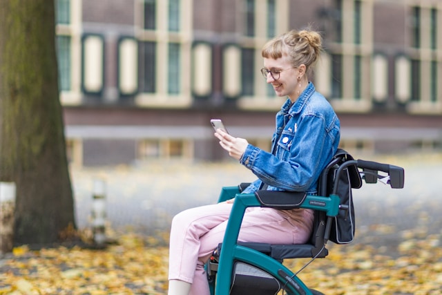 a woman on a wheelchair checking phone